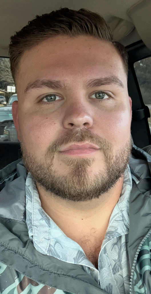 Headshot of Jake Flynn, founder of Flynn Construction, taken inside a vehicle.