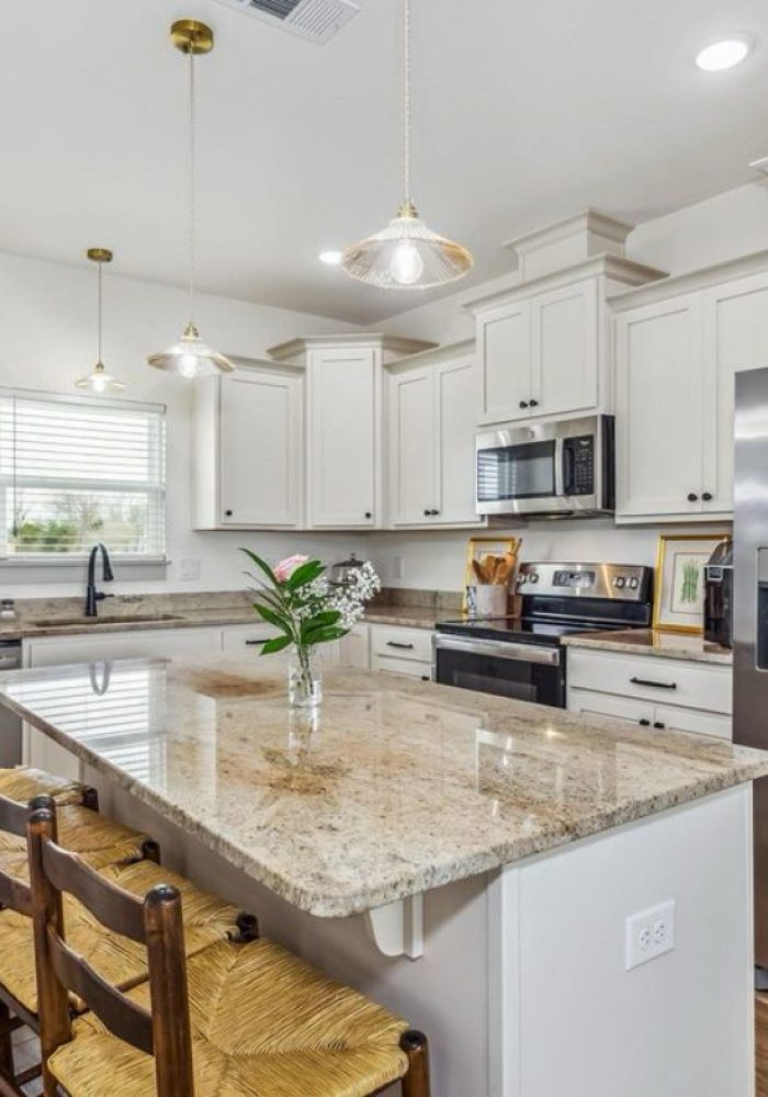 Modern kitchen with stainless appliances and stone counters